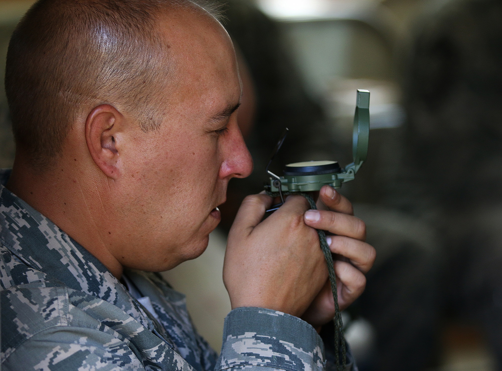 WRIGHT-PATTERSON AIR FORCE BASE, Ohio – Technical Sgt. Joseph S. Poorman, 445th Civil Engineering Squadron, reads a compass during Land Navigation training at the Warfighter Training Center Sept. 13, 2015. During the three days of training, service members covered a wide array of topics ranging from tent set-up, damage assessment response, and land navigation, to radio communications, attack preparation, and self-aid buddy care. (U.S. Air Force photo /Tech. Sgt. Patrick O’Reilly)