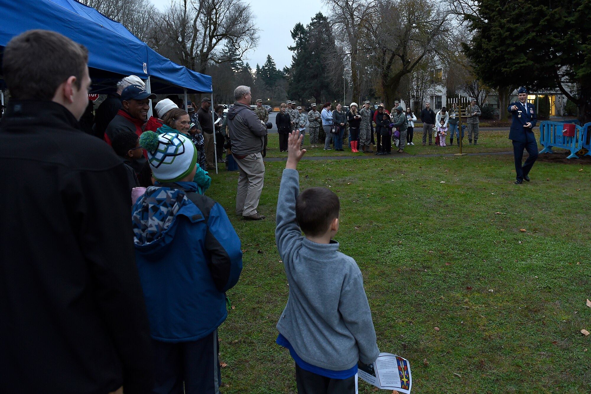 Col. Ethan Griffin, 62nd Airlift Wing vice commander, asks questions to the crowd at the McChord Field Annual Holiday Lighting Ceremony Dec. 2, 2015 at Joint Base Lewis-McChord, Wash. Col. Daniel Morgan, JBLM installation commander, also spoke at the ceremony, along with members of the 62nd AW Chaplain Corps. (U.S. Air Force photo by Tech. Sgt. Tim Chacon)