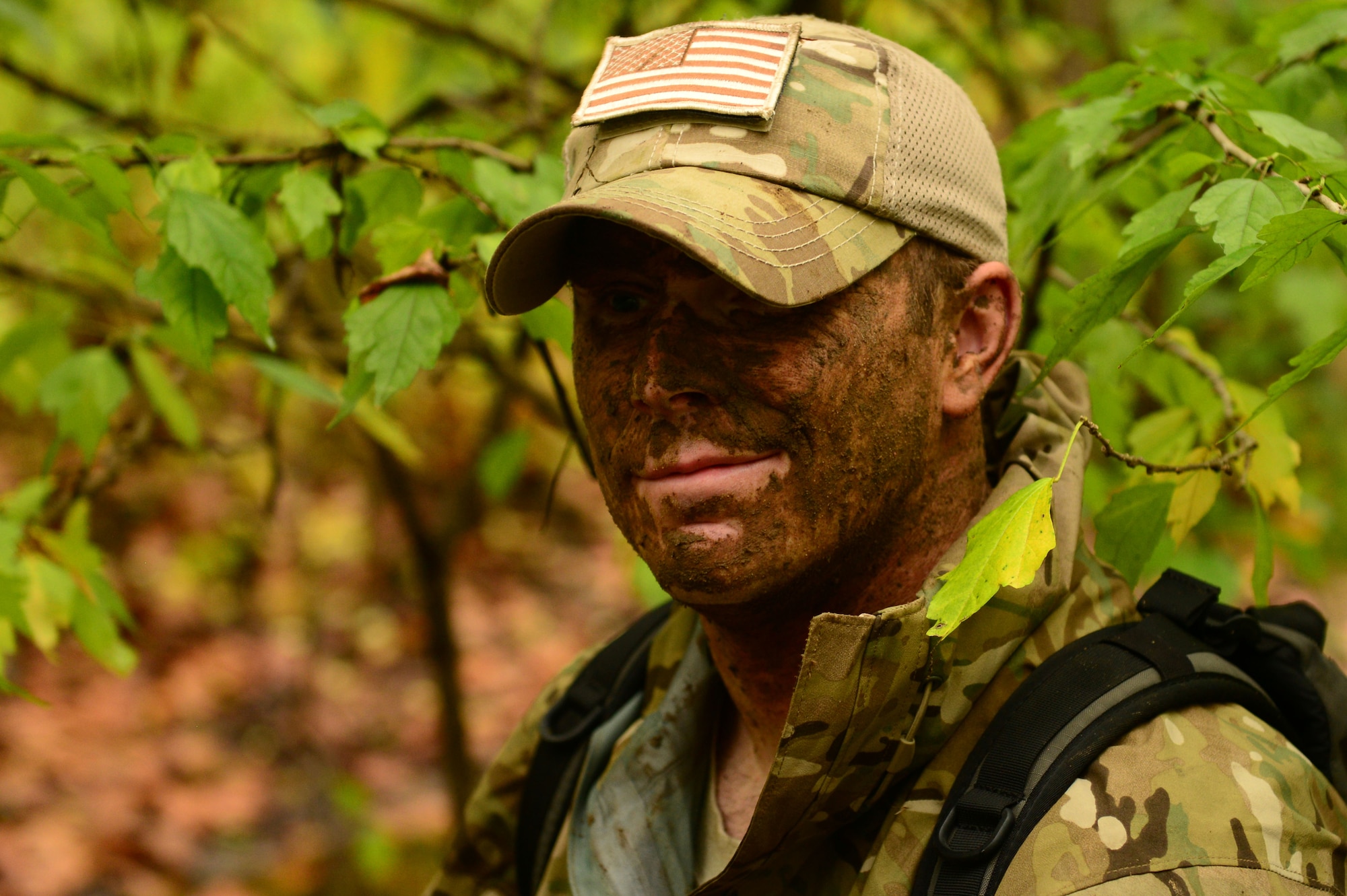 U.S. Air Force Staff Sgt. Brandon Long, a survival, evasion, resistance and escape (SERE) specialist assigned to the 1st Operations Support Squadron, demonstrates natural camouflage during SERE training at Langley Air Force Base, Va., Nov. 19, 2015. A SERE specialist trains in all major climatic conditions including arctic, desert, tropical, ocean and temperate. (U.S. Air Force photo by Airman 1st Class Derek Seifert)