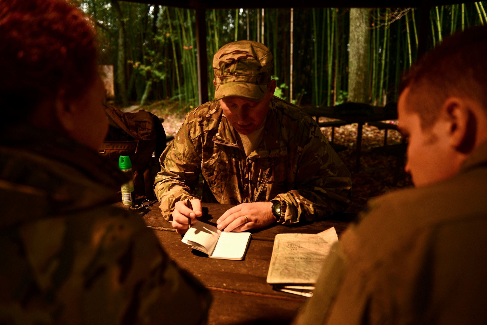 U.S. Air Force Tech. Sgt. Sean Hanson, a survival, evasion, resistance and escape (SERE) specialist assigned to the 1st Operations Support Squadron explains navigation techniques at Langley Air Force Base, Va., Nov. 19, 2015. A SERE specialist teaches Airmen how to survive in the wilderness on their own. (U.S. Air Force photo by Airman 1st Class Derek Seifert)