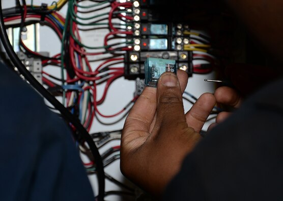 U.S. Air Force Staff Sgt. Peter Musinde, 100th Logistics Readiness Squadron NCO in charge of special purpose vehicle maintenance, inspects the heater system relays on a global deicer Nov. 24, 2015, on RAF Mildenhall, England. During the winter season, deicers are vital for aircraft operations. (U.S. Air Force photo by Gina Randall/Released)