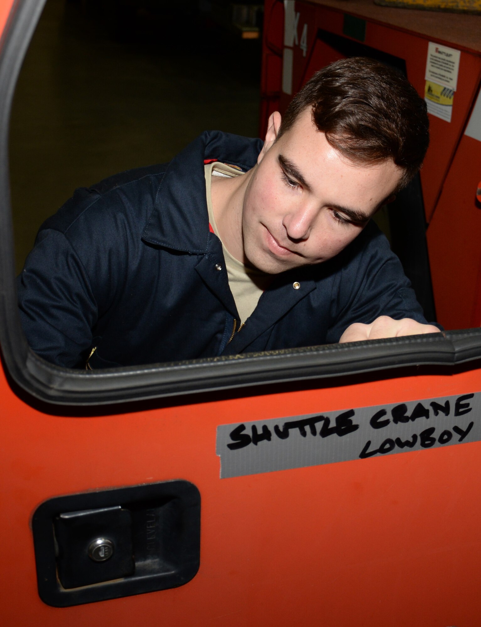 U.S. Air Force Senior Airman Samuel Lehmann, 100th Logistics Readiness Squadron vehicle maintenance journeyman, prepares to install a glass window in a door panel of a crane Nov. 24, 2015, on RAF Mildenhall, England. Safety and serviceability are paramount for both the operator and maintainer. (U.S. Air Force photo by Gina Randall/Released)