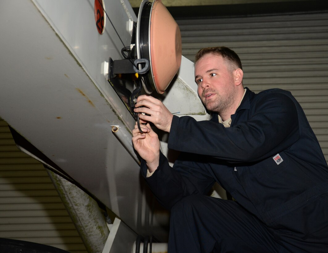 U.S. Air Force Senior Airman Joshua Floyd, 100th Logistics Readiness Squadron vehicle maintenance journeyman, inspects the wiring reel for the anti-two-block system Nov. 24, 2015, on RAF Mildenhall, England. The two-block is a saftey device that prevents the crane from being overexerted. (U.S. Air Force photo by Gina Randall/Released)
