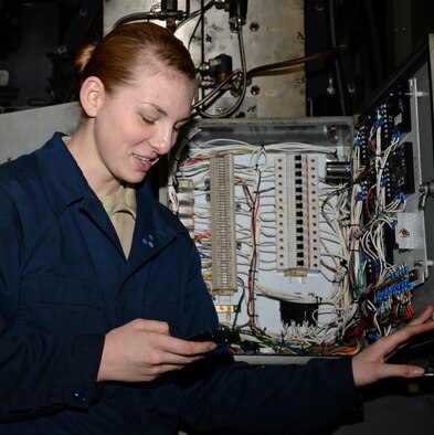 U.S. Air Force Airman 1st Class Carly Reuter, 100th Logistics Readiness Squadron vehicle maintenance journeyman, troubleshoots the electrical system on a global deicer Nov. 24, 2015, on RAF Mildenhall, England. The assigned personnel work five nights a week throughout the winter. (U.S. Air Force photo by Gina Randall/Released)