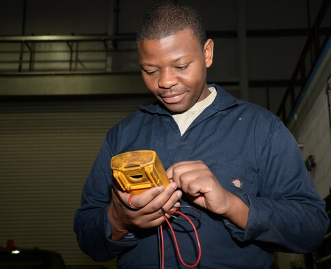 U.S. Air Force Staff Sgt. Peter Musinde, 100th Logistics Readiness Squadron NCO in charge of special purpose vehicle maintenance, sets up a multimeter to test the heater system of a global deicer Dec. 1, 2015, on RAF Mildenhall, England. Musinde returned from a deployment and now runs the night shift team for his flight. (U.S. Air Force photo by Gina Randall/Released)