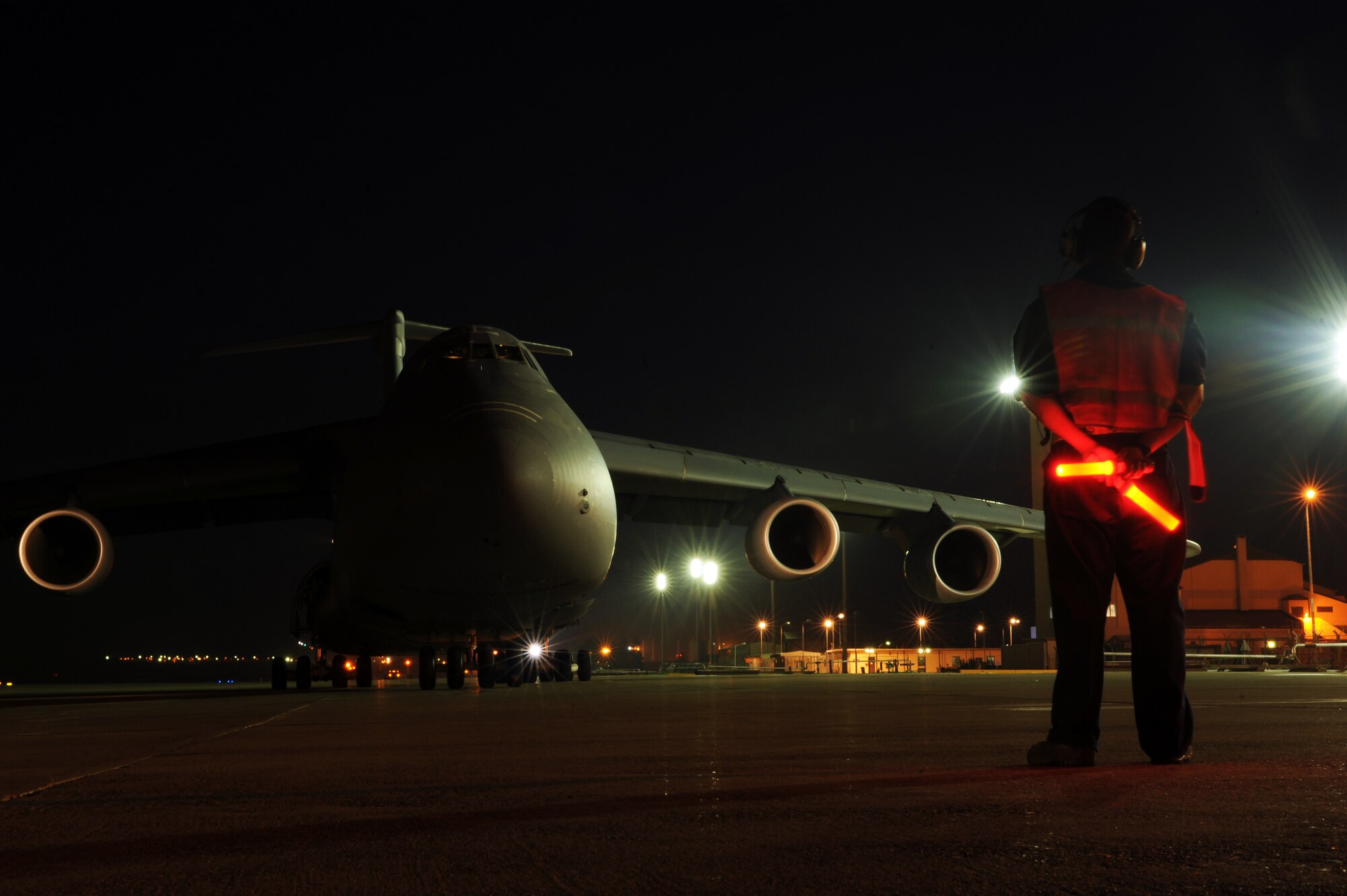 Staff Sgt. Michael Salcedo, 728th Air Mobility Squadron crew chief, prepares to marshal a C-5M Super Galaxy to a parking spot Nov. 12, 2015, at Incirlik Air Base, Turkey.  The 728th AMS receives all of the U.S. Air Force’s aircraft delivering supplies and service members to Incirlik AB in support of Operation Inherent Resolve. (U.S. Air Force photo by Airman 1st Class Daniel Lile/Released)
