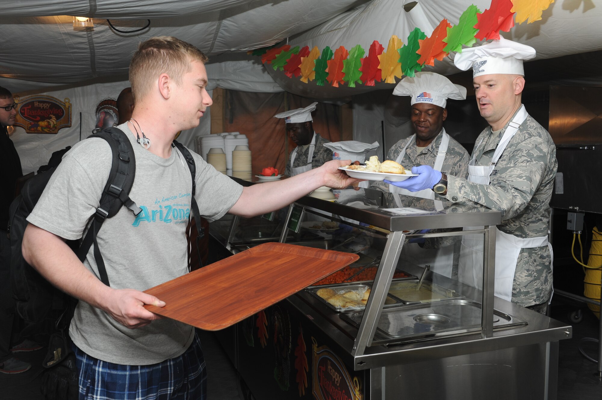 Col. Mark Anarumo, 39th Air Base Wing vice commander, serves Thanksgiving meals to Airmen at the Patriot Village dining facility Nov. 26, 2015, at Incirlik Air Base, Turkey. Dining facility workers prepared a traditional Thanksgiving meal and base leaders and their families served permanent party and deployed Airmen for lunch. (U.S. Air Force photo by Airman 1st Class Daniel Lile/Released)