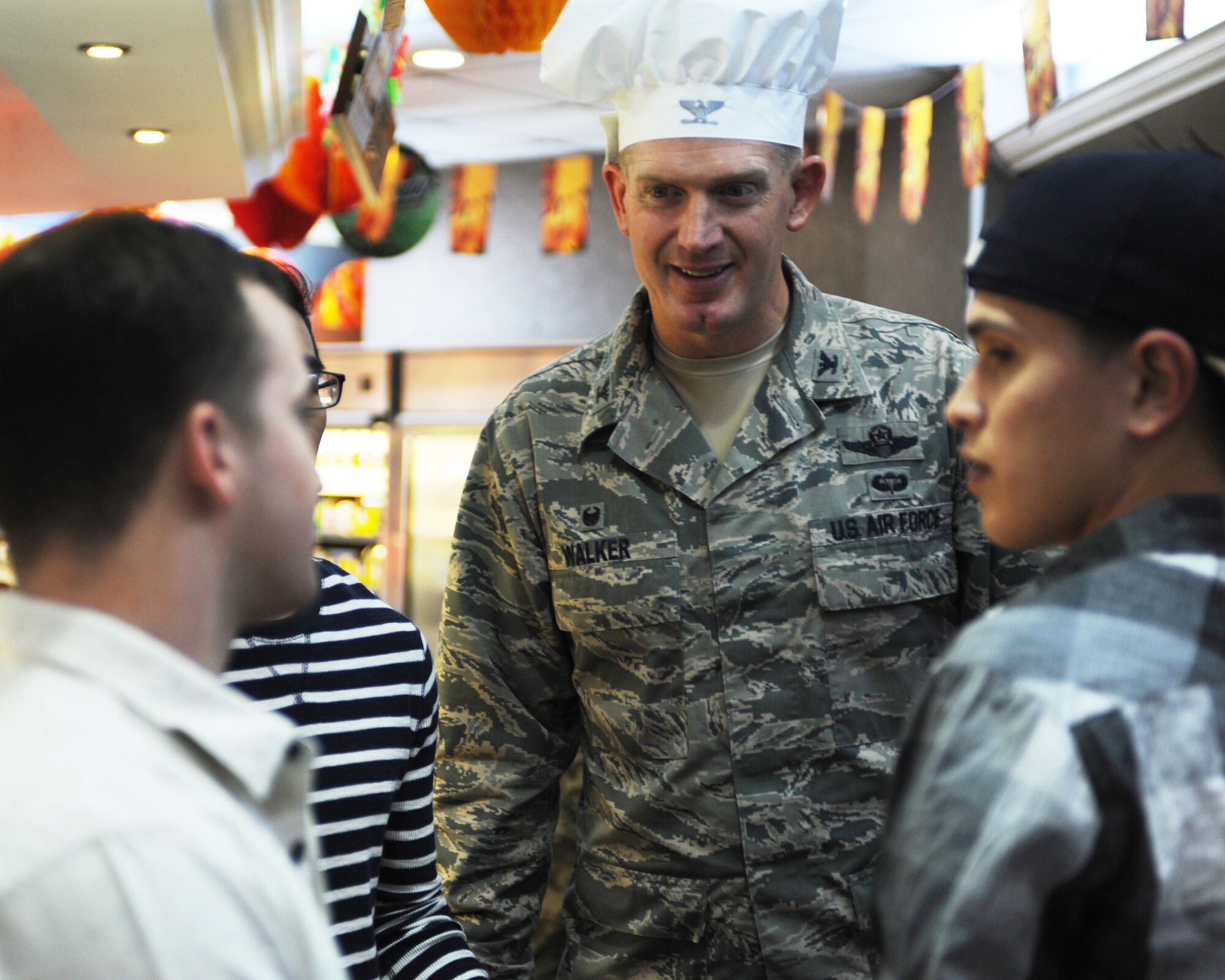 Col. John Walker, 39th Air Base Wing commander, greets Airmen during their Thanksgiving Day meal held by the Sultan’s Inn dining facility Nov. 26, 2015, at Incirlik Air Force Base, Turkey. Dining facility workers prepared a traditional Thanksgiving meal and base leaders and their families served permanent party and deployed Airmen for lunch. (U.S. Air Force photo by Airman 1st Class Daniel Lile/Released)