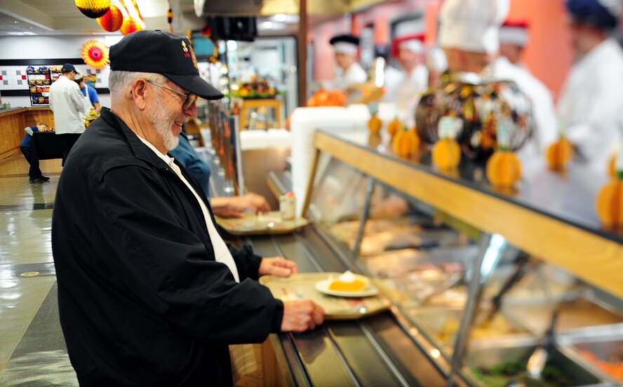 Retired U.S. Air Force Master Sgt. James Mitchell makes his way through the buffet line for a Thanksgiving meal at Whiteman Air Force Base, Mo., Nov. 26, 2015. During the luncheon, customers were treated to traditional Thanksgiving foods, to include roasted turkey, baked ham, mashed potatoes, vegetable sides and an array of desserts. (U.S. Air Force photo by Airman 1st Class Jazmin Smith)