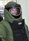 Brooks Laich, Washington Capitals Centerman, demonstrates proper wear of Explosive Ordnance Disposal (EOD) suit during the team’s tour of Joint Base Andrews Dec. 1, 2015. The EOD suit or a blast suit is a heavy suit of body armor designed to withstand the pressure generated by a bomb and any fragments the bomb may produce. The visit included performances by Max Impact and the Air Force Honor Guard, aircraft tours, team-building activities, a demonstration by the Security Forces military working dogs, and lunch at the Joint Base Andrews Dining Facility. (U.S. Air Force photo/James E. Lotz)