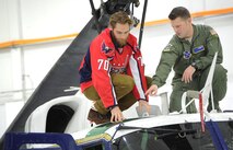 Staff Sergeant John Michael Harry, Explosive Ordnance Disposal (EOD) Technician, 11th Wing Civil Engineer Squadron, talks about the United States Air Force EOD mission with the Washington Capitals players during the team’s tour of Joint Base Andrews Dec. 1, 2015. The visit included performances by Max Impact and the Air Force Honor Guard, aircraft tours, team-building activities, a demonstration by the Security Forces military working dogs, and lunch at the Joint Base Andrews Dining Facility. (U.S. Air Force photo/James E. Lotz)