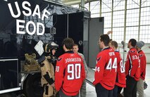 Staff Sergeant John Michael Harry, Explosive Ordnance Disposal (EOD) Technician, 11th Wing Civil Engineer Squadron, talks about the United States Air Force EOD mission with the Washington Capitals players during the team’s tour of Joint Base Andrews Dec. 1, 2015. The visit included performances by Max Impact and the Air Force Honor Guard, aircraft tours, team-building activities, a demonstration by the Security Forces military working dogs, and lunch at the Joint Base Andrews Dining Facility. (U.S. Air Force photo/James E. Lotz)