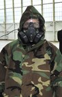 Nate Schmidt, Washington Capitals defenseman, demonstrates proper wear of Chemical - Biological - Radiological - Nuclear (CBRN) personal protective equipment during the team’s tour of Joint Base Andrews Dec. 1, 2015. The visit included performances by Max Impact and the Air Force Honor Guard, aircraft tours, team-building activities, a demonstration by the Security Forces military working dogs, and lunch at the Joint Base Andrews Dining Facility. (U.S. Air Force photo/James E. Lotz)