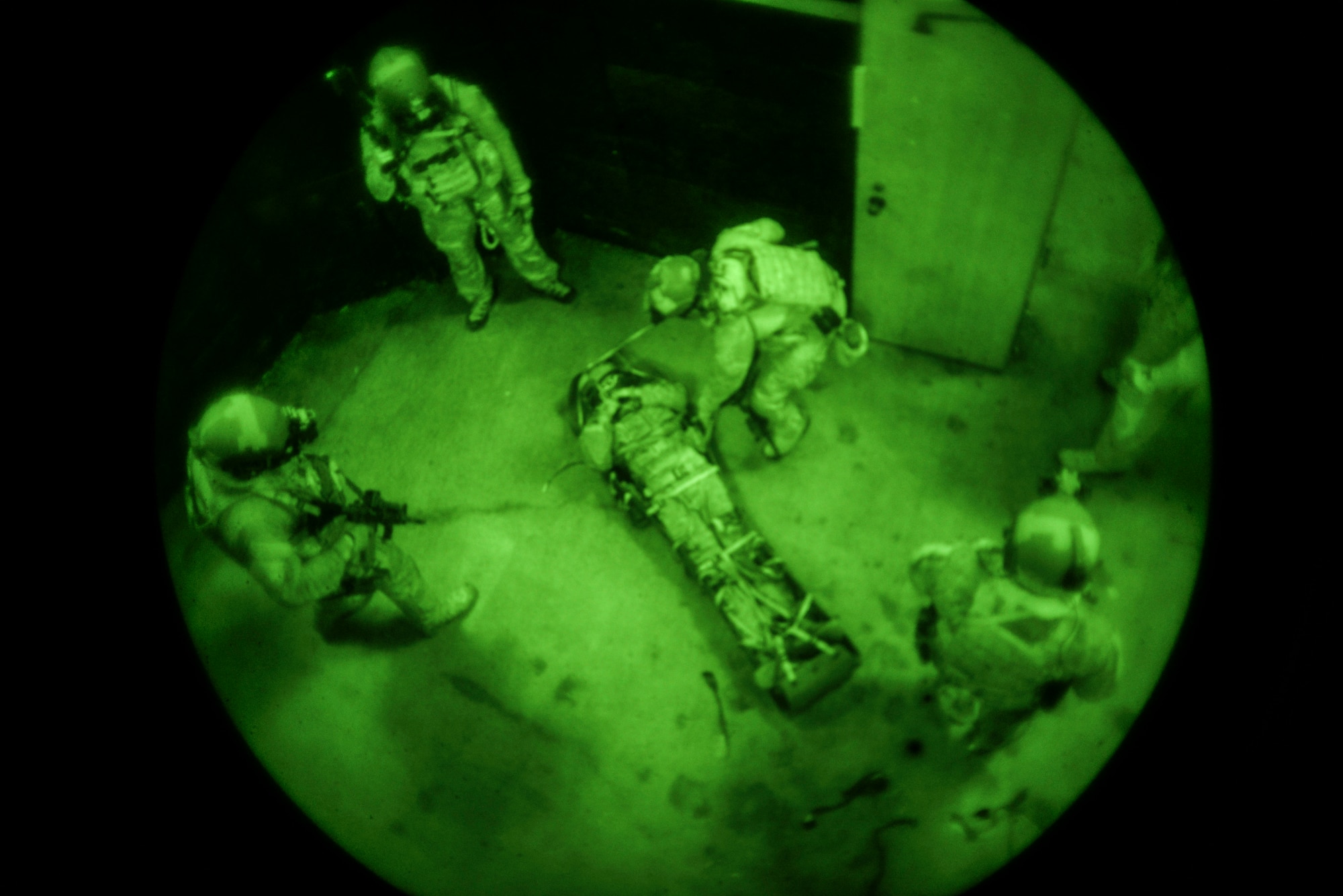 Airmen from the 320th Special Tactics Squadron prepare to extract a mock casualty after securing a shoot house Nov. 19, 2015, at Camp Hansen, Japan. Members of the 320th STS train frequently to improve their life saving skills as they can be called upon to use them at any time. (U.S. Air Force photo by John Linzmeier)