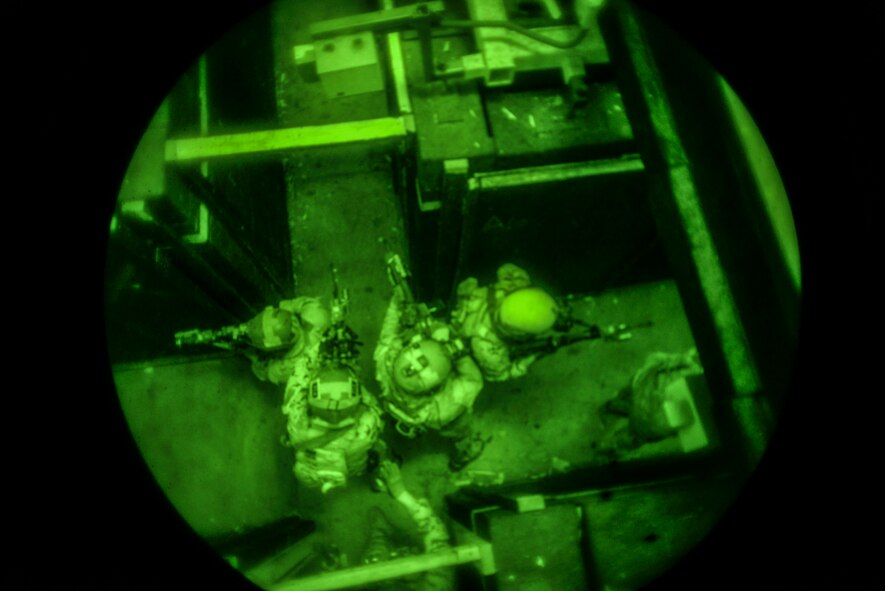 Airmen from the 320th Special Tactics Squadron infiltrate and secure a section of a shoot house Nov. 19, 2015, at Camp Hansen, Japan. The Airmen participated in a two-week training course that enhanced teamwork skills, enabling members to quickly adapt to a new special operations team if needed for mission requirements. (U.S. Air Force photo by John Linzmeier)