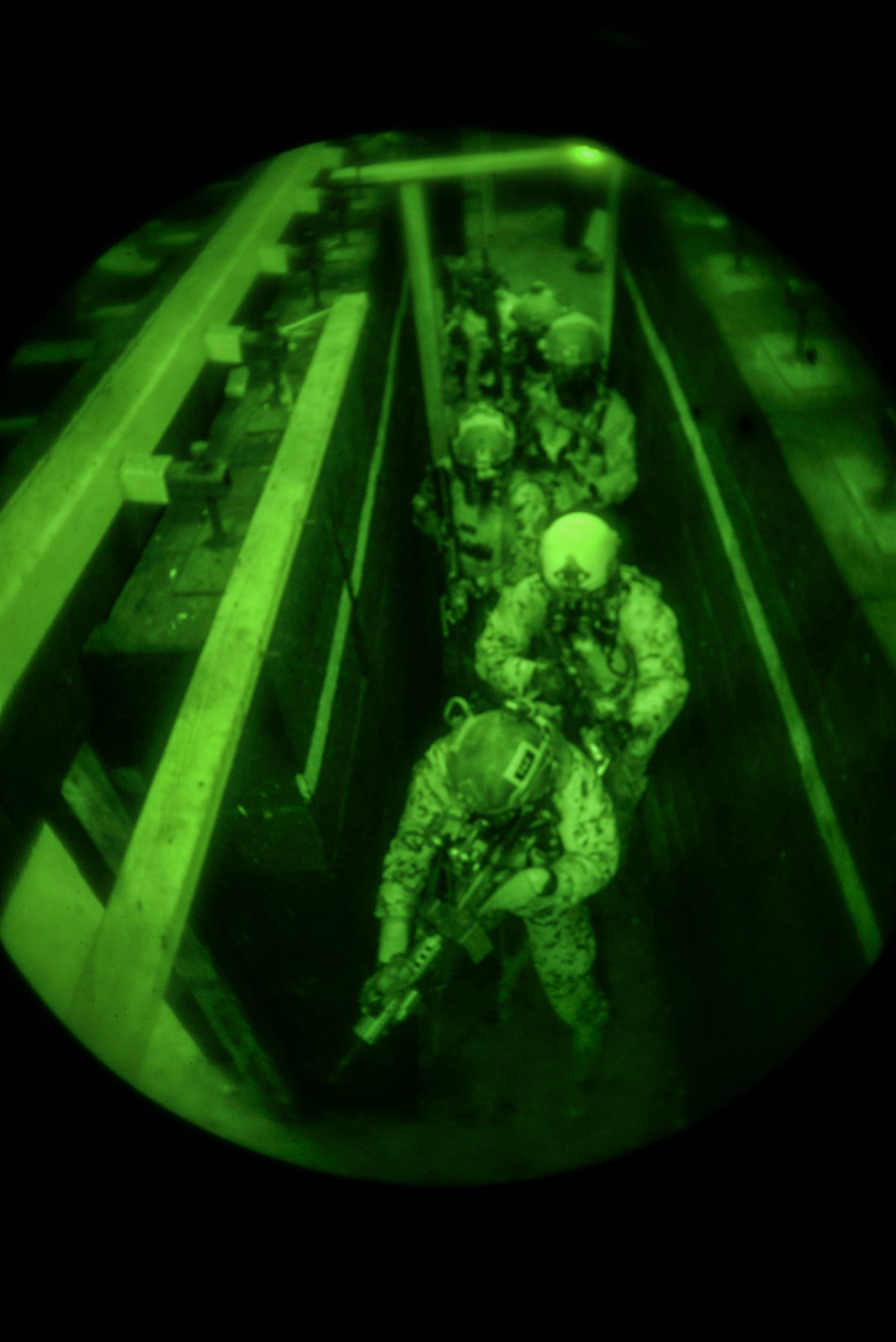 A team of Airmen from the 320th Special Tactics Squadron move down a hallway in a shoot house Nov. 19, 2015, at Camp Hansen, Japan. The Airmen cleared the house as part of training led by the Direct Action Resource Center. The two-week course developed skills that the pararescuemen, combat controllers and force reconnaisance marines will use when they deploy with other joint special operations teams. (U.S. Air Force photo by Senior Airman John Linzmeier)