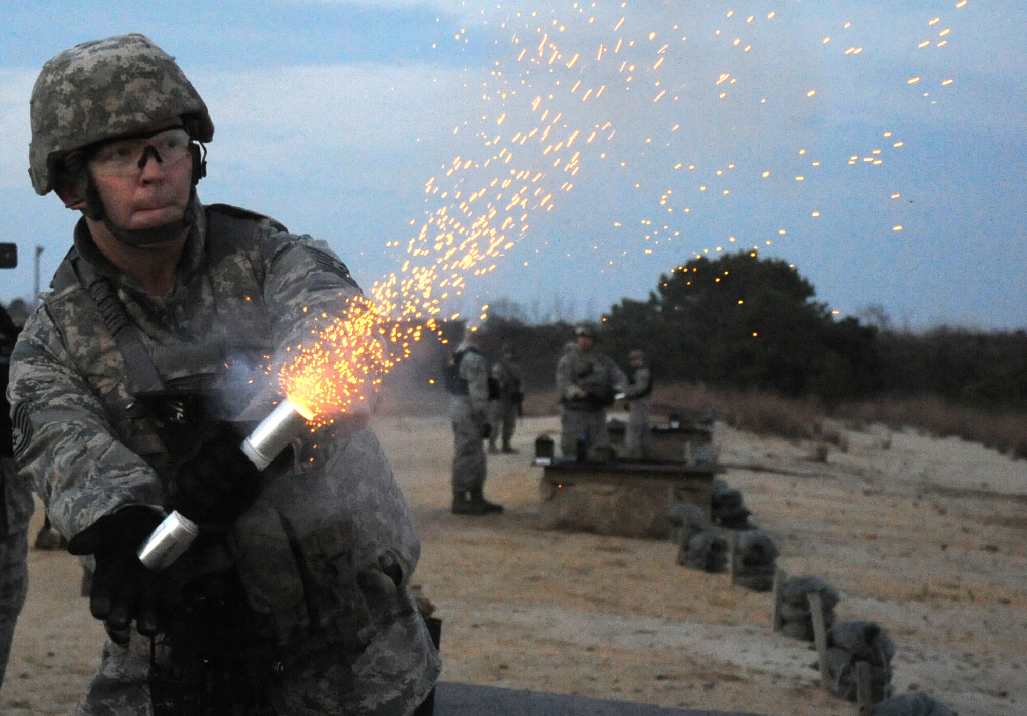 A Field Craft - Contingency Response proof of concept student fires a flare during night fire training on Nov. 6, 2015, at Joint Base McGuire-Dix-Lakehurst, New Jersey. The 14-day training course was designed to improve how Contingency Response Airmen are trained in air base opening combat skills. (U.S. Air Force photo/Tech. Sgt. Chris Powell)