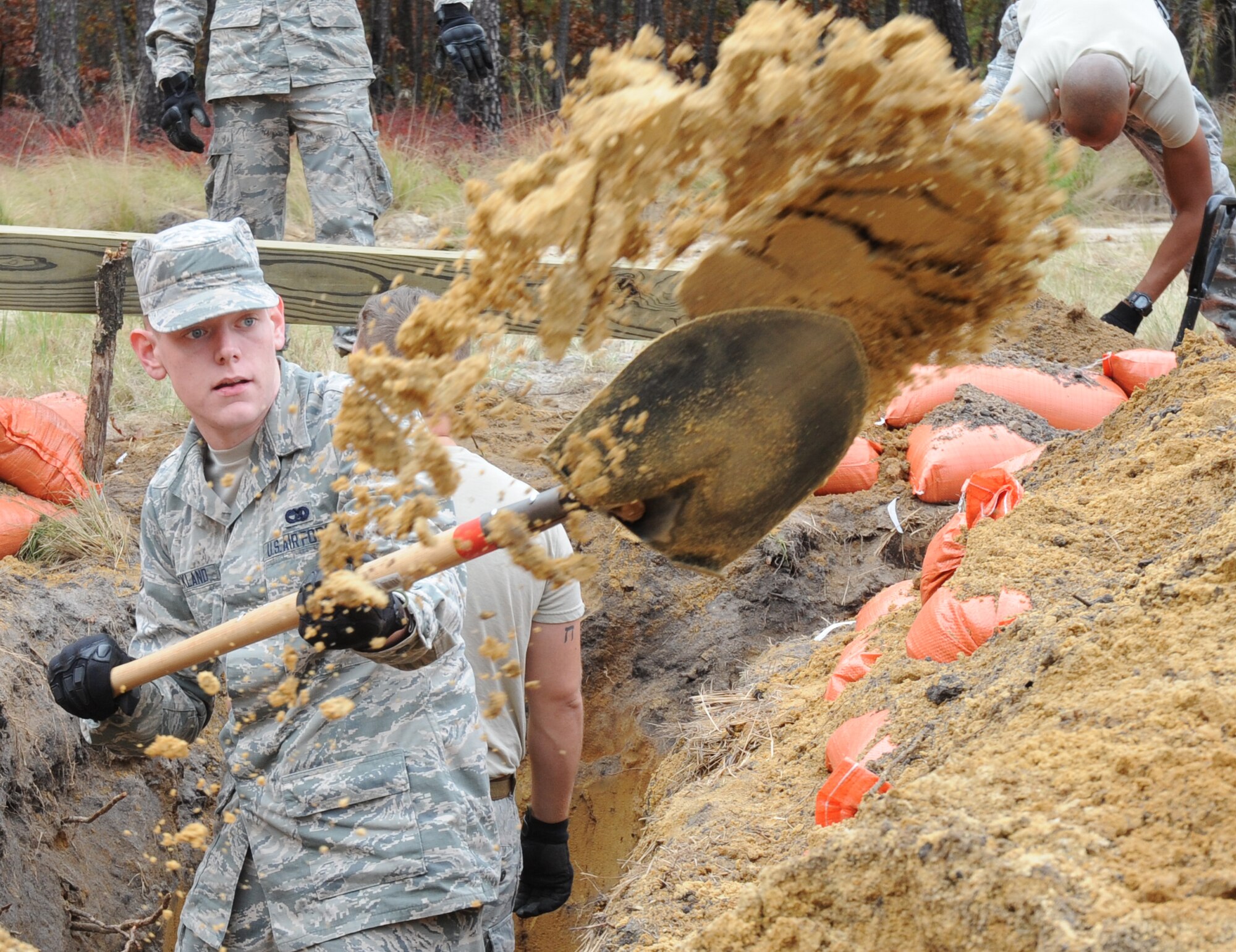 Airman Kelly Strickland digs a hole for a defensive fighting position during the Field Craft - Contingency Response proof of concept on Nov. 2, 2015, at Joint Base McGuire-Dix-Lakehurst. Strickland is assigned to the 621st Contingency Response Wing. The 14-day training course was designed to improve how Contingency Response Airmen are trained in air base opening combat skills. (U.S. Air Force photo/Tech. Sgt. Chris Powell)