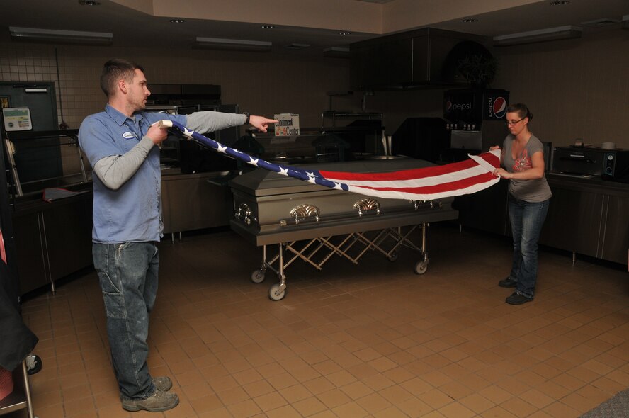 Members of the 120th Airlift Wing Base Honor Guard attend an evening training session Nov. 17, 2015 in the wing dining facility. Tech. Sgt. Quinn Nelson instructs Senior Airman Michelle Brugman in the proper technique of folding a flag for military funeral honors. (U.S. Air National Guard photo by Senior Master Sgt. Eric Peterson/Released)

