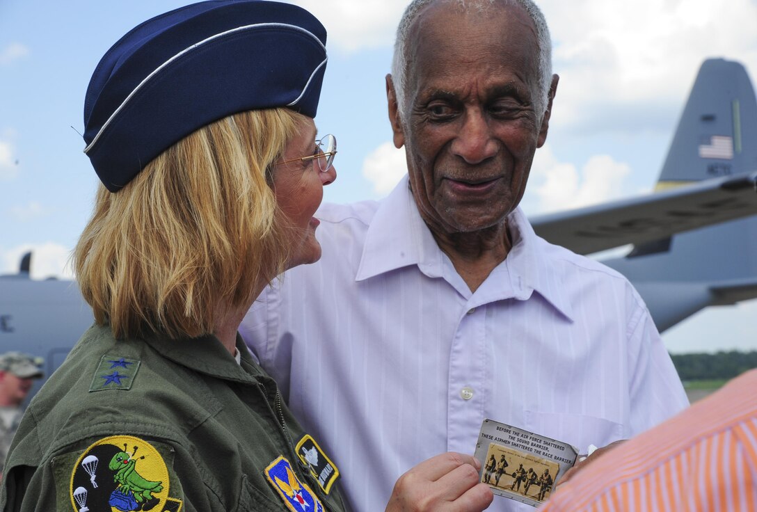 Milton P. Crenchaw speaks with U.S. Air Force Maj. Gen. Margaret H. Woodward Aug. 20, 2013, at Little Rock Air Force Base, Ark. Crenchaw overcame social injustices of racism to serve his country during World War II as a civilian flight instructor.