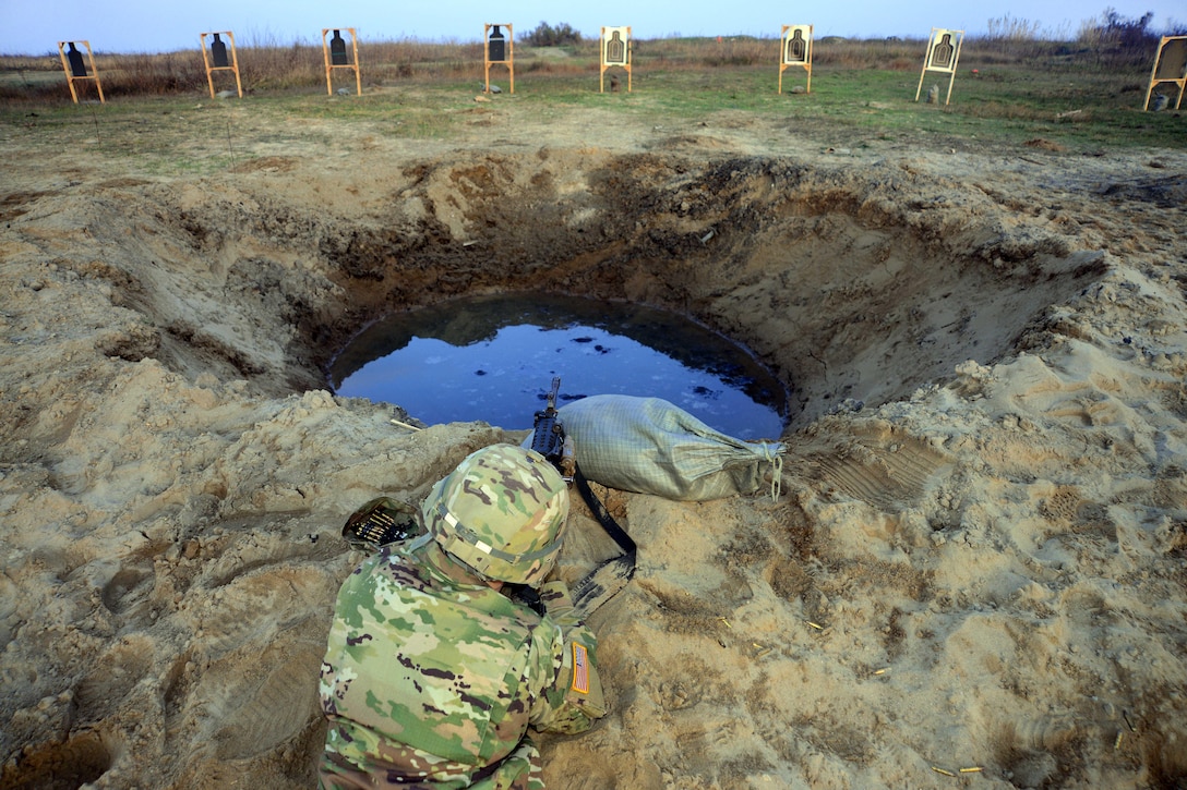 A U.S. Army paratrooper conducts training with an M249 light machine gun at a training area near Ravenna, Italy, Nov 30, 2015. The soldier is assigned to Company C, 1st Battalion, 503rd Infantry Regiment, 173rd Airborne Brigade. U.S. Army photo by Elena Baladelli