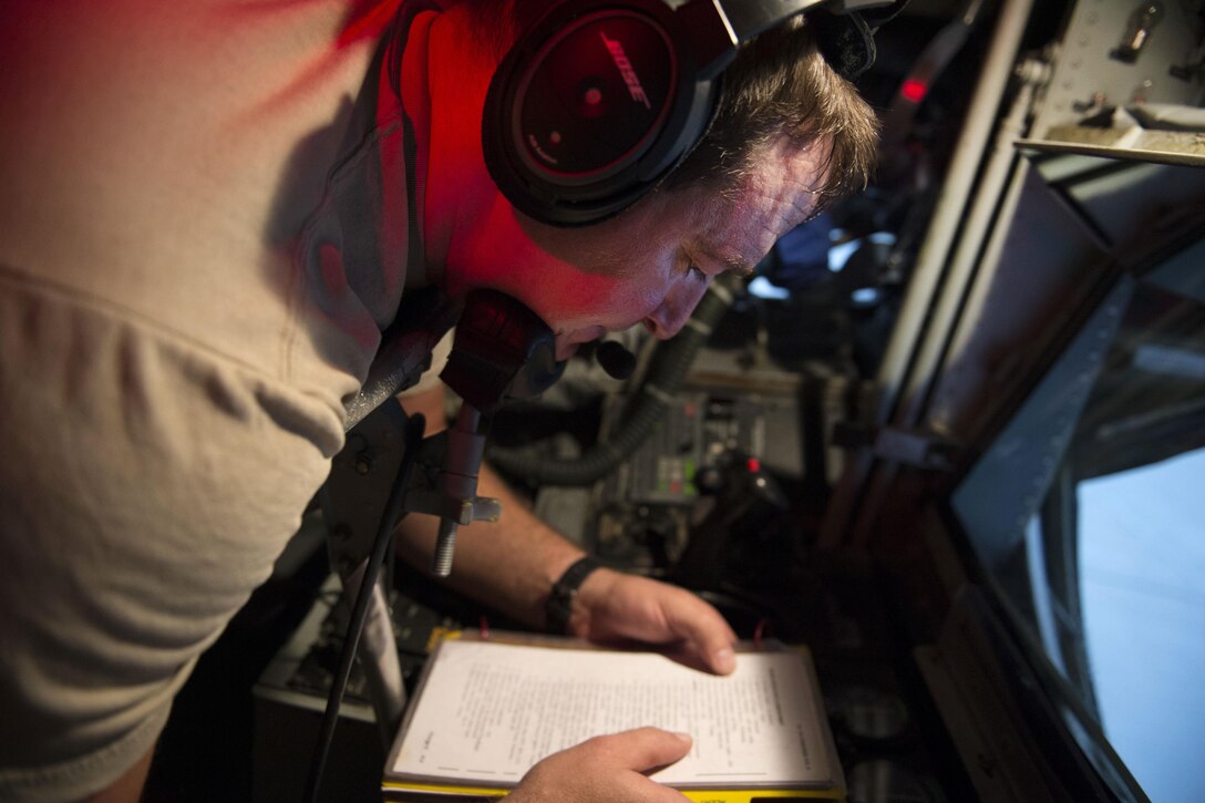 U.S. Air Force Tech. Sgt. James Marier performs preflight checks on an aircraft before departing from Al Udeid Air Base, Qatar, to refuel F-16 aircraft in support of Operation Inherent Resolve over Southwest Asia, Dec. 1, 2015. Marier is a boom operator assigned to the 340th Expeditionary Air Refueling Squadron. U.S. Air Force photo by Tech. Sgt. Nathan Lipscomb