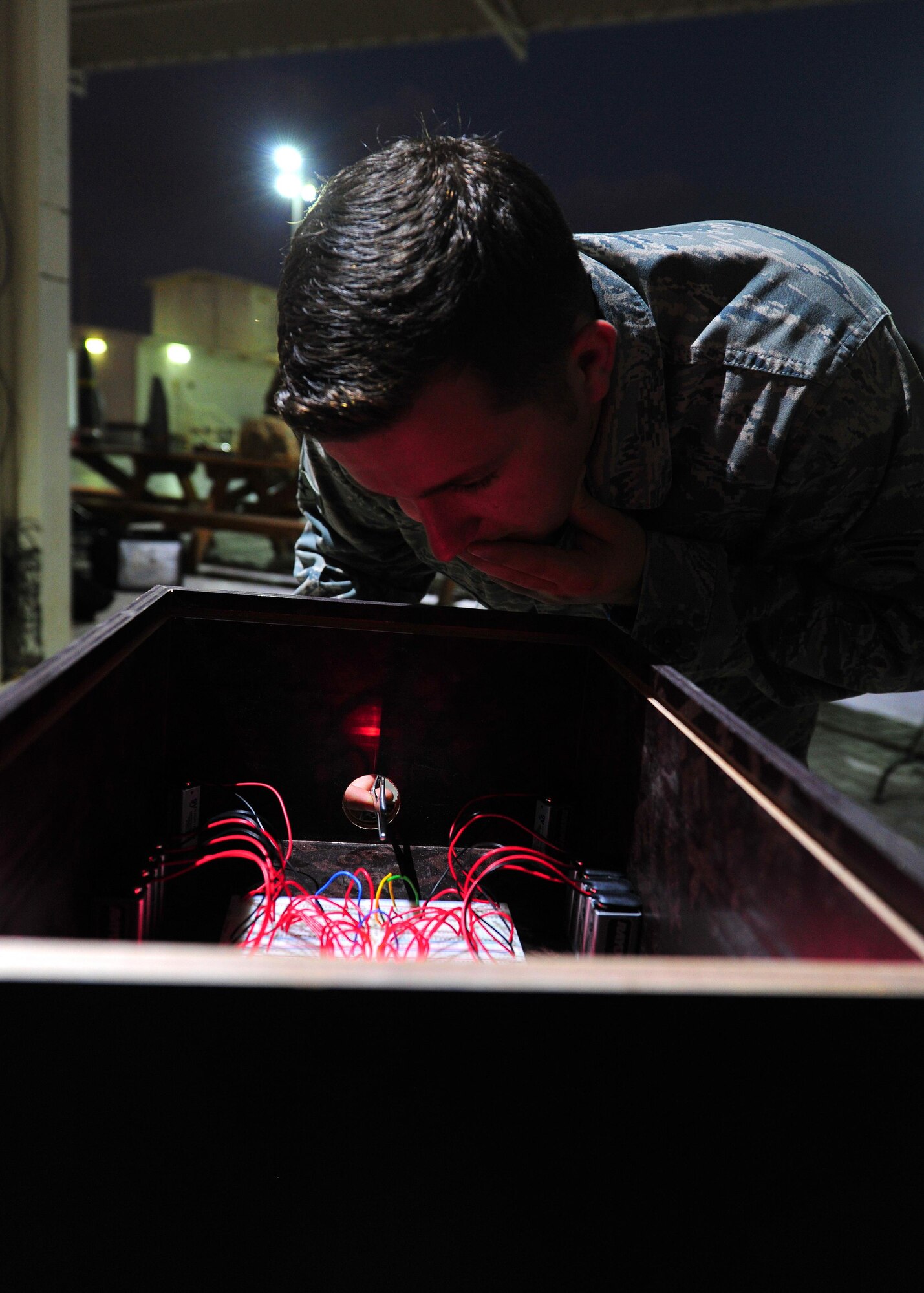 Senior Airman Christopher, 380th Expeditionary Medical Group mental health technician, attempts to trace and cut an electrical circuit as part of the Disarm the Bomb Challenge during the Explosive Ordnance Disposal Capabilities Carnival at an undisclosed location in Southwest Asia, Nov. 27, 2015. The purpose of the carnival was to familiarize U.S. and coalition personnel with the various equipment and techniques utilized by EOD Airmen.  (U.S. Air Force photo by Staff Sgt. Kentavist P. Brackin/Released)
