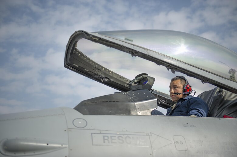 Tech. Sgt. Carlo Patalinghug, 455th Expeditionary Aircraft Maintenance Squadron crew chief, deployed Hill Air Force Base, Utah, lowers the canopy on an F-16 Fighting Falcon before running up the engine to test a hydraulic leak repair.  The squadron provides combat-ready aircraft to the air component commander in support of coalition forces throughout Afghanistan. (U.S. Air Force Photo by Tech. Sgt. Robert Cloys/Released)
