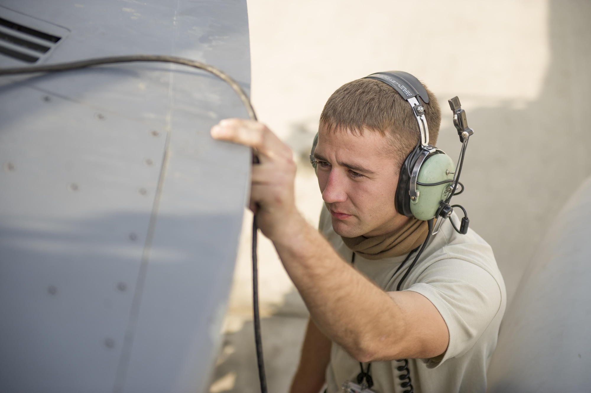 Airman 1st Class Drew Owens, 455th Expeditionary Aircraft Maintenance Squadron crew chief, deployed Hill Air Force Base, Utah, examines an F-16 Fighting Falcon during a hydraulic leak repair at Bagram Airfield, Afghanistan, Nov. 30, 2015.  The squadron provides combat-ready aircraft to the air component commander in support of coalition forces throughout Afghanistan. (U.S. Air Force Photo by Tech. Sgt. Robert Cloys/Released)