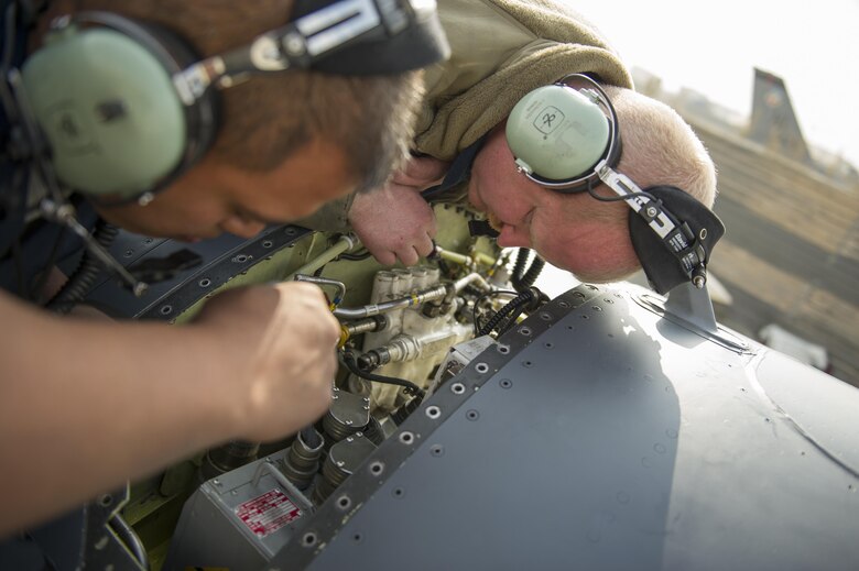 Senior Airman Jason Miranda, right, and Tech. Sgt. Carlo Patalinghug, 455th Expeditionary Aircraft Maintenance Squadron crew chiefs, deployed Hill Air Force Base, Utah, examine an F-16 Fighting Falcon while repairing a hydraulic leak on the aircraft's leading edge flap at Bagram Airfield, Afghanistan, Nov. 30, 2015.  The squadron provides combat-ready aircraft to the air component commander in support of coalition forces throughout Afghanistan. (U.S. Air Force Photo by Tech. Sgt. Robert Cloys/Released)