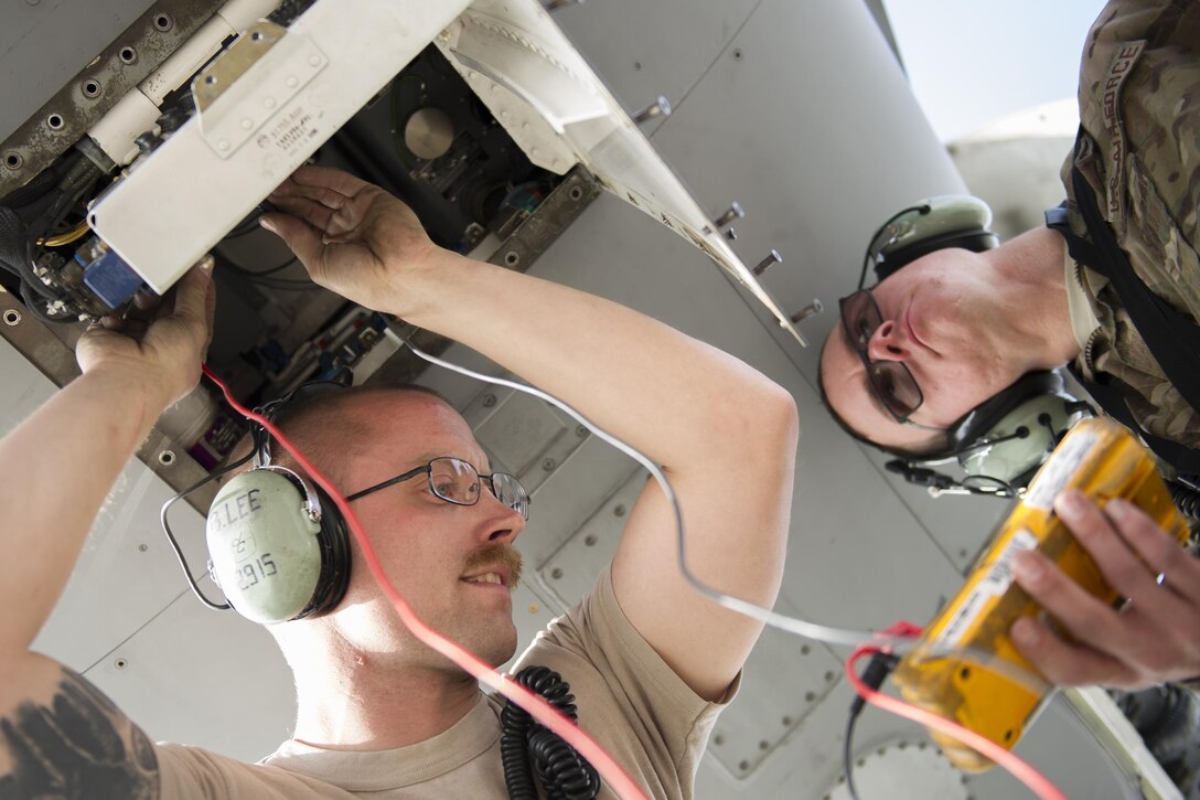 Staff Sgt. Brendan Lee and Senior Airman Travis Legg, 455th Expeditionary Aircraft Maintenance Squadron avionics technicians, deployed from Hill Air Force Base, Utah,  troubleshoot an F-16 Fighting Falcon with a faulty radar module at Bagram Airfield, Afghanistan, Nov. 30, 2015. The squadron provides combat-ready aircraft to the air component commander in support of coalition forces throughout Afghanistan. (U.S. Air Force Photo by Tech. Sgt. Robert Cloys/Released)