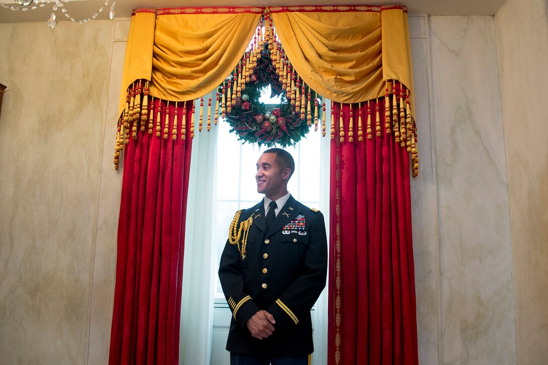 Army Capt. Mark Searles, a Joint Chiefs of Staff fellowship recipient at Georgetown University, stands by to direct guests at the White House in Washington, D.C., Dec. 2, 2015. Searles volunteered for an event honoring military families and giving them a first look at the White House’s holiday decorations. DoD photo by EJ Hersom 