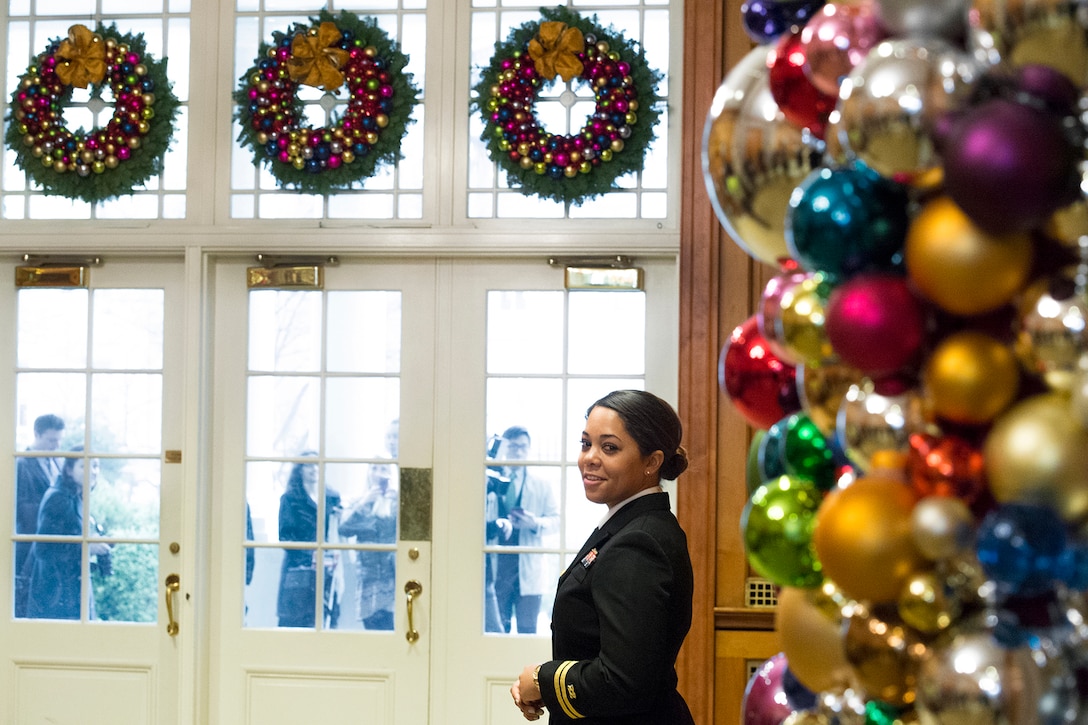 Navy Lt. Adrienne Rolle, a White House social aide, helps control the flow of journalists into the White House for a holiday event in Washington, D.C., Dec. 2, 2015. DoD photo by EJ Hersom
