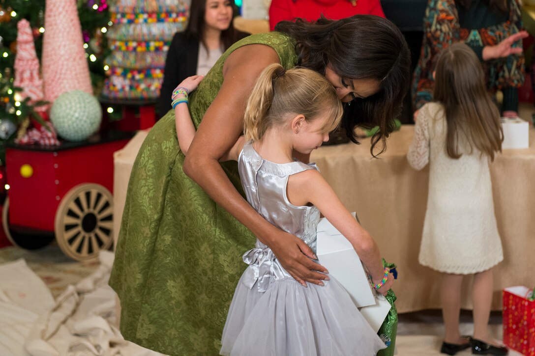First Lady Michelle Obama talks with a child while hosting military family members during a holiday event at the White House, Dec. 2, 2015. DoD photo by EJ Hersom
