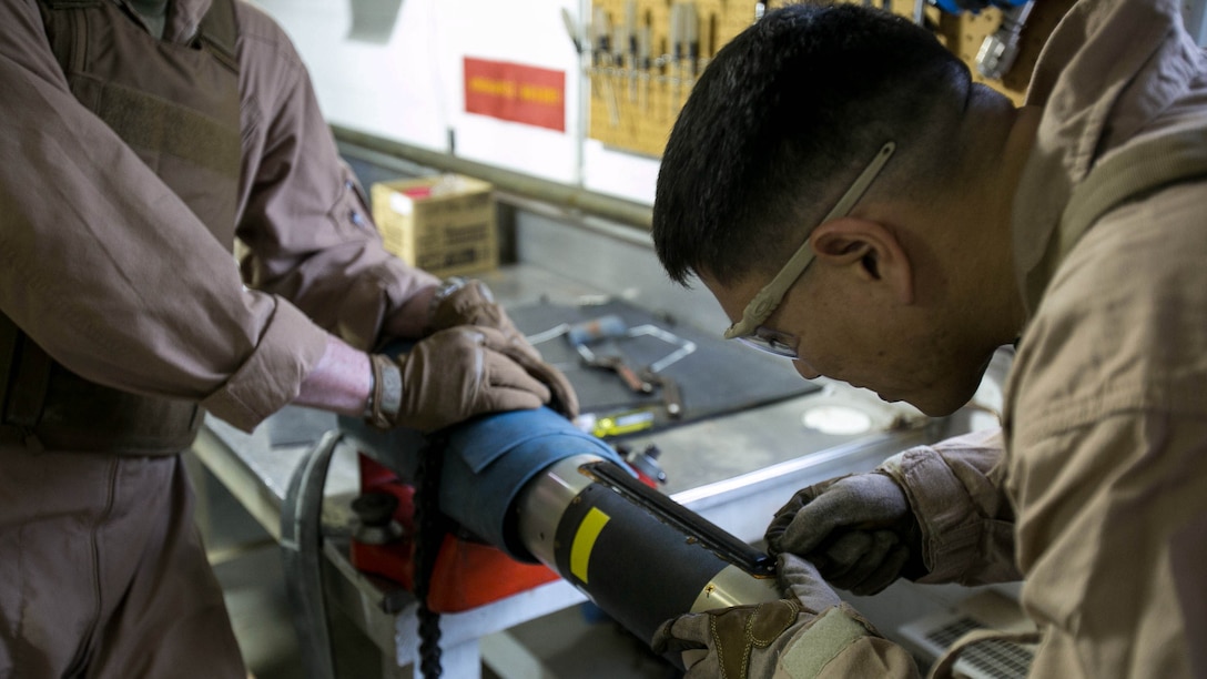 Master Sgt. Jerry Slattum, an Explosive Ordnance Disposal technician with EOD Company, cautiously works on dismantling the Griffin missile to remove the explosives from the missile at Marine Corps Base Camp Lejeune, N.C., Dec. 1, 2015. A Griffin missile is an air and ground-launched, precise, low collateral-damage missile used for irregular warfare operations. 
