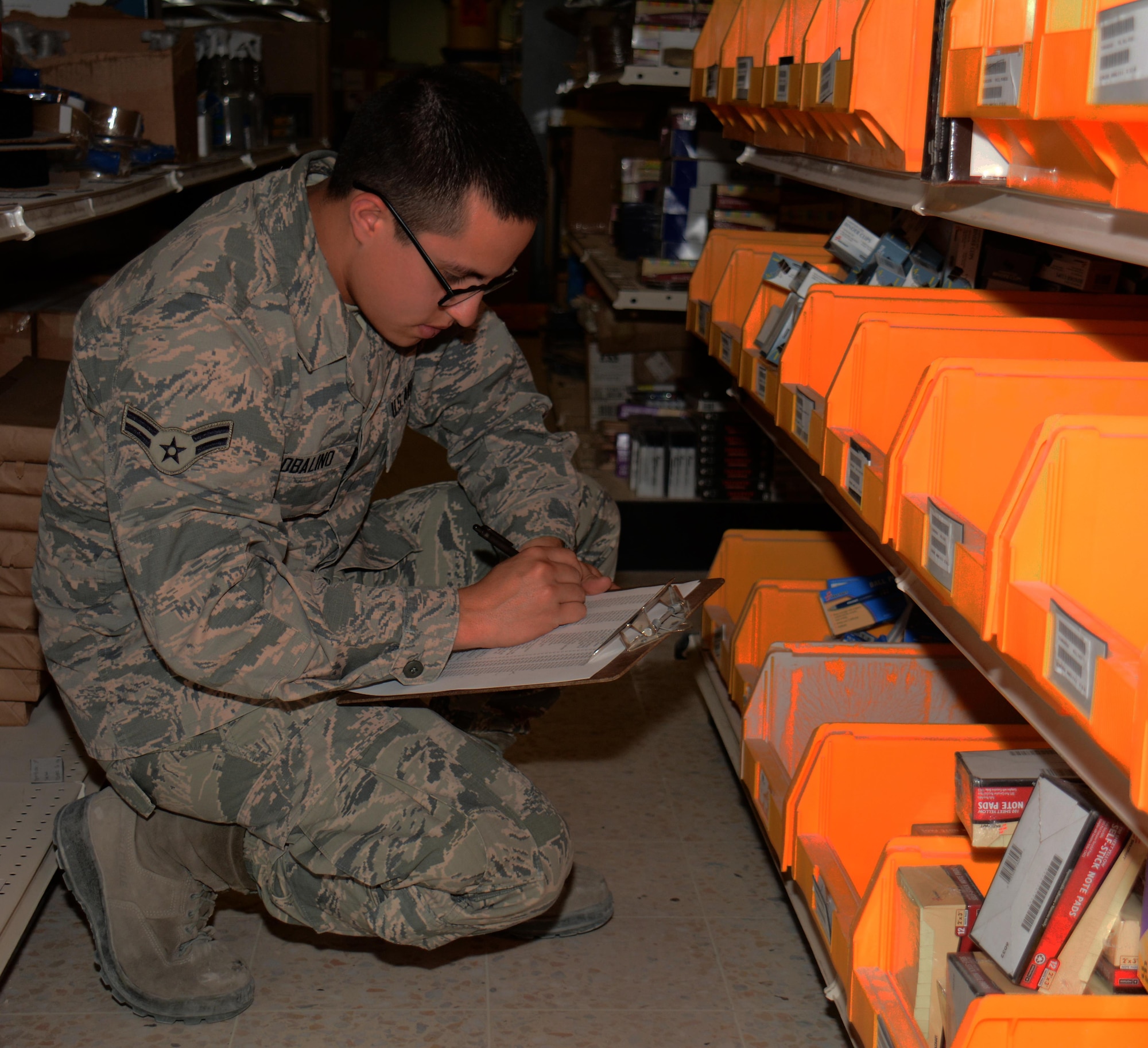Airman 1st Class Juan Robalino, 379th Expeditionary Logistics Readiness Squadron Desert Depot journeyman, inventories office supplies at Al Udeid Air Base, Qatar Dec. 3. Robalino, a native of Quito, Ecuador, said it’s important to track items properly so accountability is maintained. Since July 2015 the Desert Depot has issued more than 146,000 items valued at $1.4 Million. (U.S. Air Force photo by Tech. Sgt. James Hodgman/Released)