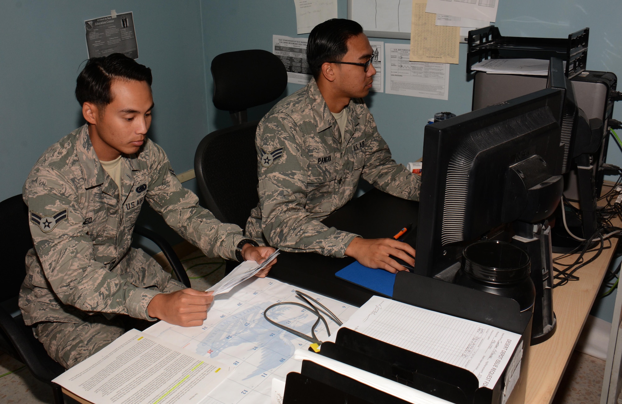 Airman 1st Class Donnie Keo from Modesto, California (Left) and Senior Airman Jeffrey Pangan from Las Vegas, Nevada (Right), both 379th Expeditionary Logistics Readiness Squadron Desert Depot journeymen, review Desert Depot’s inventory in the Enterprise Supply System at Al Udeid Air Base, Qatar Dec. 3. The system helps the Desert Depot staff track products and orders. Since July 2015 the Desert Depot has issued more than 146,000 items valued at $1.4 Million. (U.S. Air Force photo by Tech. Sgt. James Hodgman/Released)