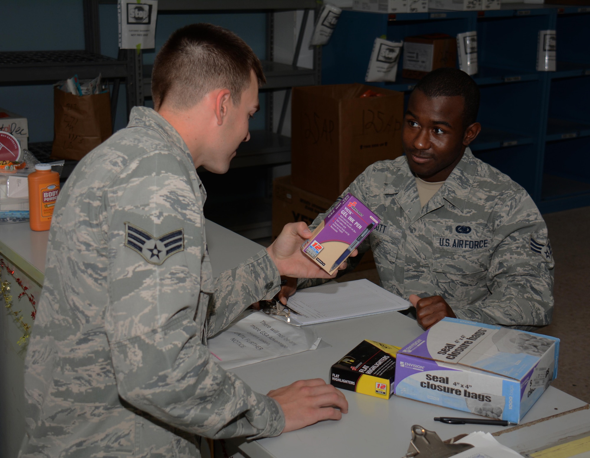 Senior Airman Larry Scott, 379th Expeditionary Logistics Readiness Squadron Desert Depot journeyman, assists a customer with a supply purchase inside the Desert Depot at Al Udeid Air Base, Qatar Dec. 3. Scott, a native of Greenwood, Mississippi, said he enjoys helping customers. Since July 2015 the Desert Depot has issued more than 146,000 items valued at $1.4 Million. (U.S. Air Force photo by Tech. Sgt. James Hodgman/Released)