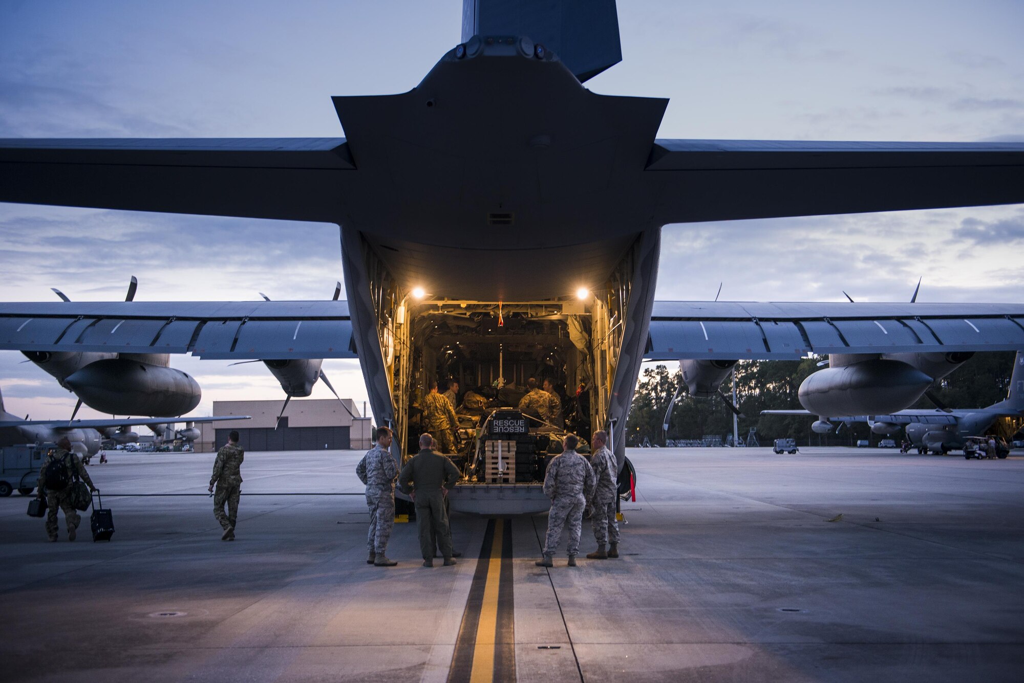 Airmen from the 71st Rescue Squadron secure cargo in the back of an HC-130J Combat King II Nov. 27, 2015, at Moody Air Force Base, Ga. The Airmen deployed in support of Operation Inherent Resolve. (U.S. Air Force photo/Senior Airman Ryan Callaghan)