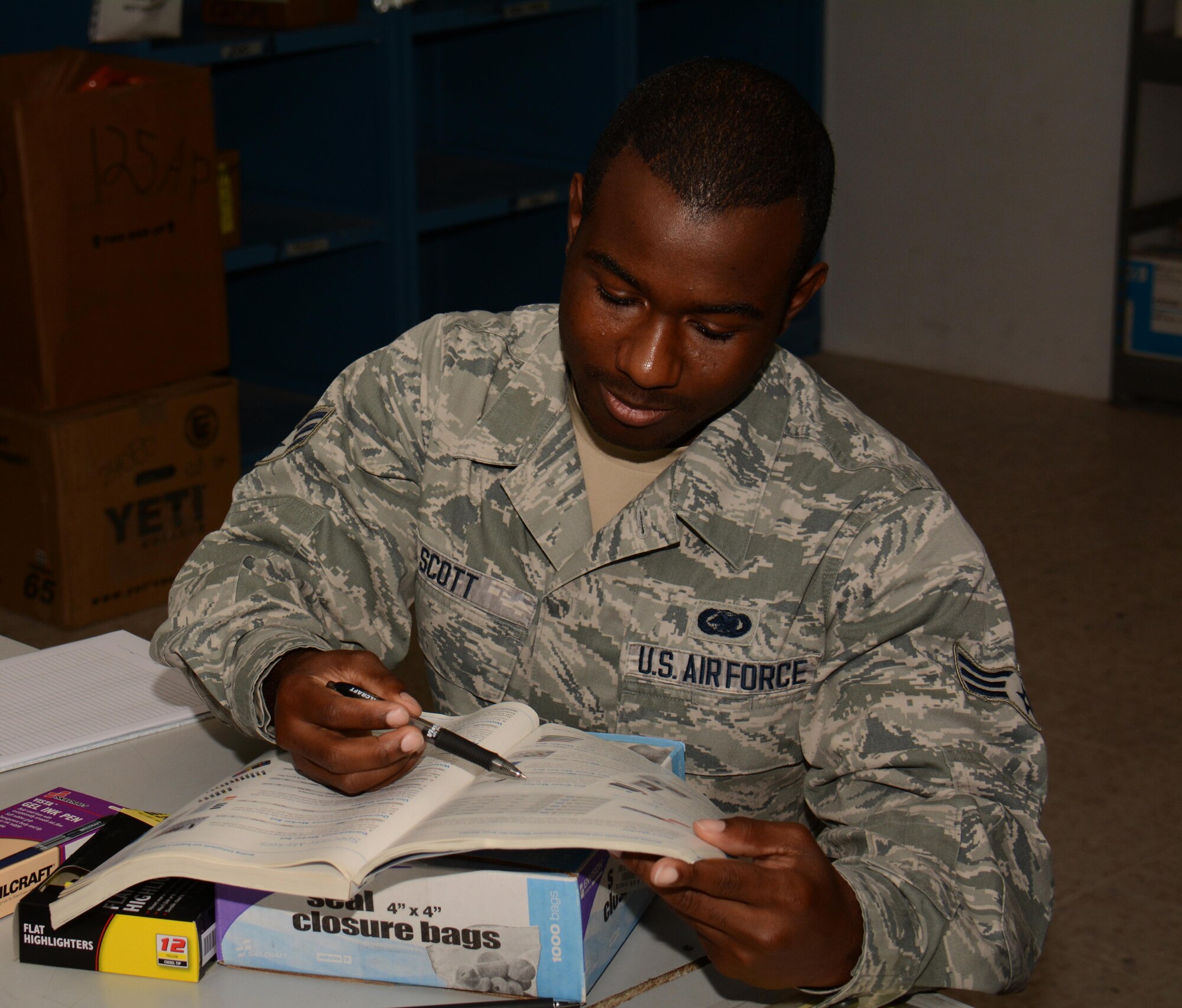 Senior Airman Larry Scott, 379th Expeditionary Logistics Readiness Squadron Desert Depot journeyman,assists a customer with a supply purchase inside the Desert Depot at Al Udeid Air Base, Qatar Dec. 3. Scott, a native of Greenwood, Mississippi, said he enjoys helping customers. Since July 2015 the Desert Depot has issued more than 146,000 items valued at $1.4 Million. (U.S. Air Force photo by Tech. Sgt. James Hodgman/Released)