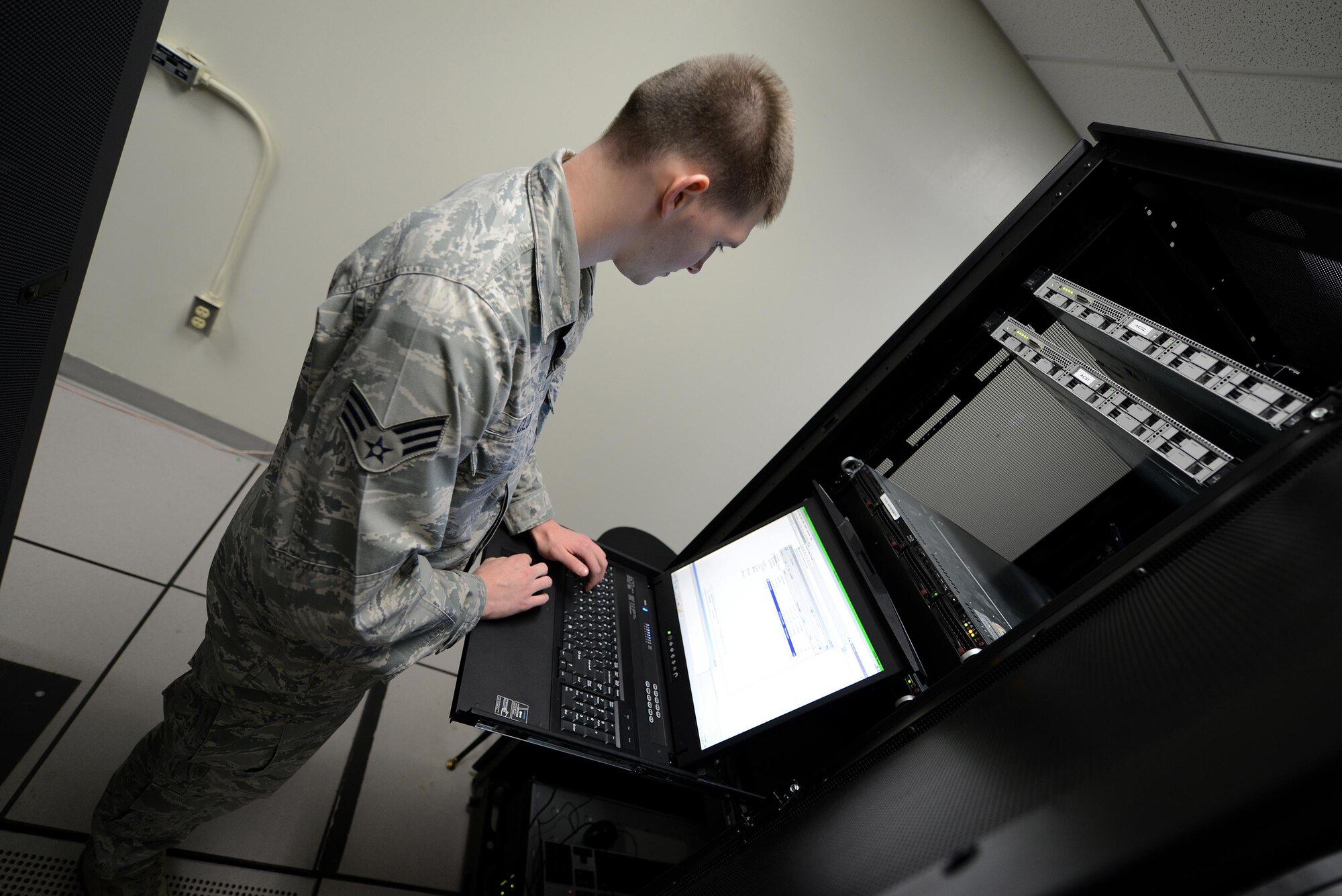 Senior Airman Daniel Clouse, 47th Communications Squadron cyber transport technician, configures a server on Laughlin Air Force Base, Texas, Dec. 1, 2015. Clouse was recently named the Air Force Outstanding Cyber Systems Airman at the Air Education and Training Command level for his outstanding performance. (U.S Air Force photo by Airman 1st Class Ariel D. Partlow)