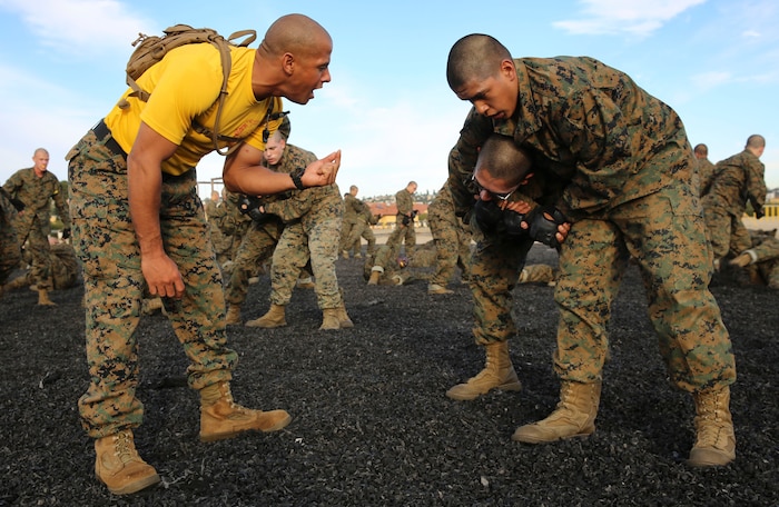 A drill instructor of Fox Company, 2nd Recruit Training Battalion, advises a recruit on how to execute a counter choke during a Marine Corps Martial Arts Program session at Marine Corps Recruit Depot San Diego, Nov. 30. Recruits were instructed to partner up with the recruit next to them and take turns executing each technique. Earning a tan belt comes after recruits complete the basic stage of MCMAP in recruit training. Marines have the opportunity to obtain higher levels in their Marine Corps careers. Today, all males recruited west of the Mississippi are trained at MCRD San Diego. The depot is responsible for training more than 16,000 recruits annually. Fox Company is scheduled to graduate Jan. 29.