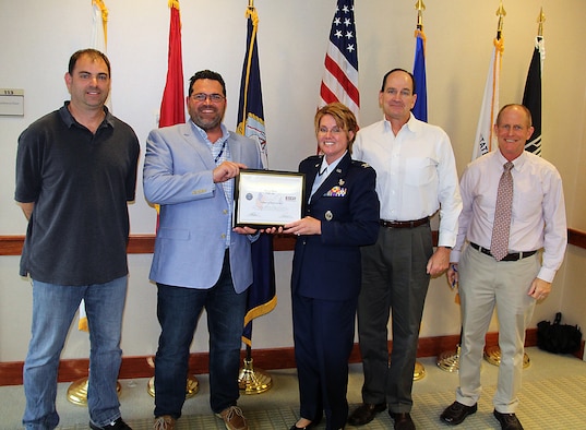 (From Left) Charles Cantrell, an 81st Aerial Port Squadron Reservist, Steven Haas, Cantrell's civilian supervisor, Col. Cherie Roff, 315th Mission Support Group commander, Robert Carruthers, vice president of hardware integration and logistics at Science Applications International Corporation, and David Greenfield, vice president of Operations at SAIC pose for a photo after Roff presented the Employer Support of the Guard and Reserve's Patriot Award to Cantrell's civilian supervisor Dec. 2, 2015 at the company's North Charleston, S.C. location.  (U.S. Air Force Photo by Michael Dukes)