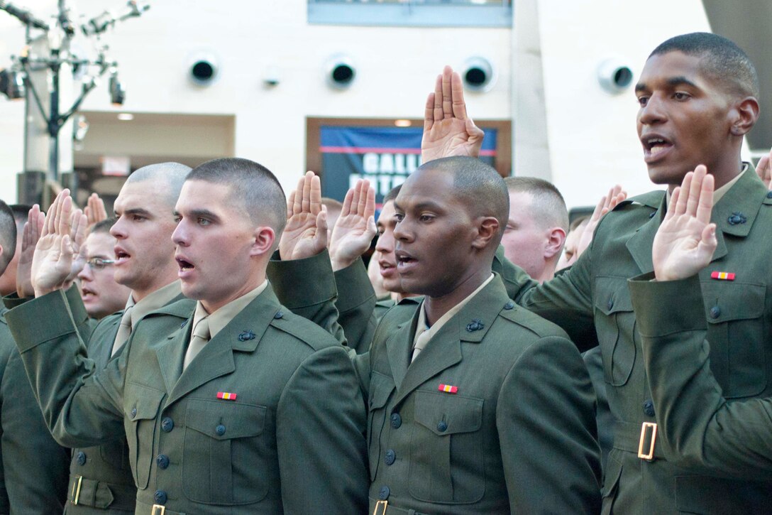 Officer candidates from Class 220 recite the Oath Of Office during their commissioning ceremony Nov. 24 at the National Museum of the Marine Corps in Triangle, Va.  These new second lieutenants now head to The Basic School.