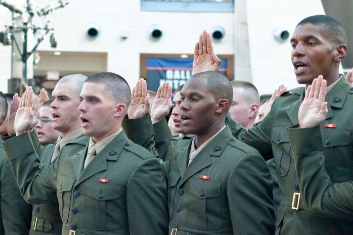 Officer candidates from Class 220 recite the Oath Of Office during their commissioning ceremony Nov. 24 at the National Museum of the Marine Corps in Triangle, Va.  These new second lieutenants now head to The Basic School.