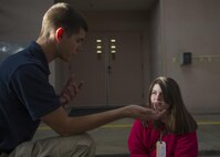 Senior Airman Chance Pettey, a member of the National Air and Space Intelligence Center, speaks with a Young Marine member participating in the Community Emergency Response Team exercise Oct. 17, 2015 at the Huber Heights Fire Department. Pettey is a volunteer for the fire department as a community educator on the community outreach team. (U.S. Air Force Photo by Senior Airman Justyn M. Freeman)