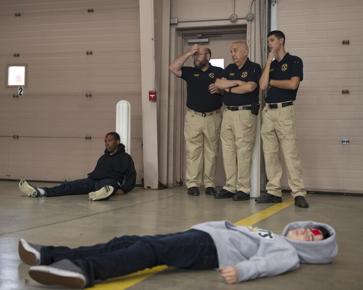 Senior Airman Chance Pettey (right), a member of the National Air and Space Intelligence Center, speaks with Young Marines staff members participating in the Community Emergency Response Team exercise Oct. 17, 2015 at the Huber Heights Fire Department. Pettey is a volunteer for the fire department as a community educator on the community outreach team. (U.S. Air Force Photo by Senior Airman Justyn M. Freeman)