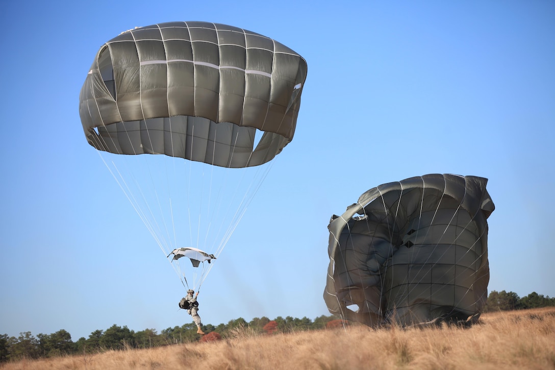 Paratroopers conduct parachute landing falls as part a proficiency jump program over the Sicily drop zone on Fort Bragg, Nov. 21, 2015. U.S. Army photo by Spc. Darius D. Davis