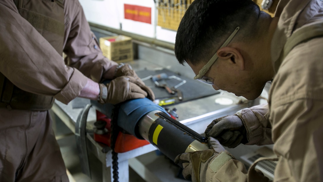 Master Sgt. Jerry Slattum, an Explosive Ordnance Disposal technician with EOD Company, cautiously works on dismantling the Griffin missile to remove the explosives from the missile at Marine Corps Base Camp Lejeune, N.C., Dec. 1, 2015. A Griffin missile is an air and ground-launched, precise, low collateral-damage missile used for irregular warfare operations. 