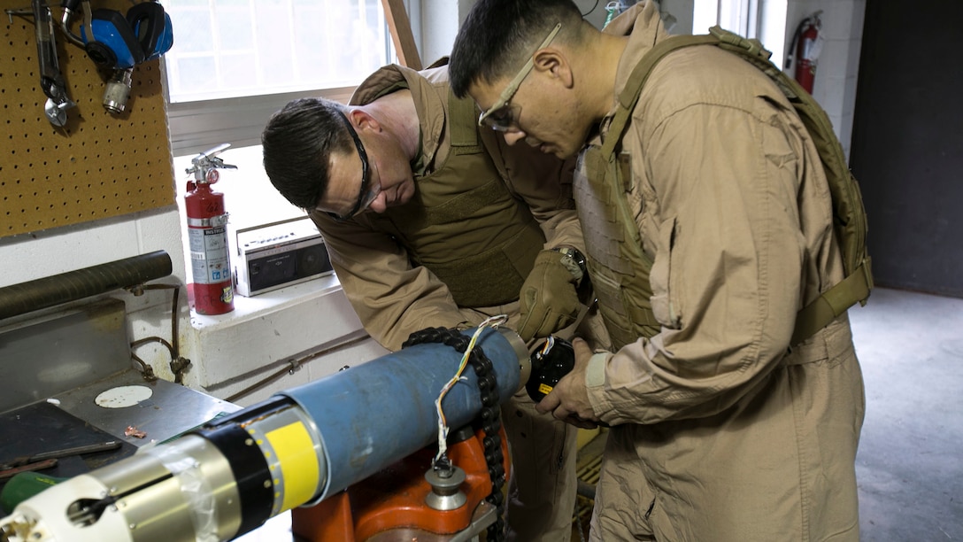 Chief Warrant Officer 2 Jason Scarborough, left, and Master Sgt. Jerry Slattum, Explosive Ordnance Disposal technicians with EOD Company, take off the dome of the warhead to remove the explosive ordnance at Marine Corps Base Camp Lejeune, N.C., Dec. 1, 2015. A Griffin missile is an air and ground-launched, precise, low collateral-damage missile used for irregular warfare operations. 